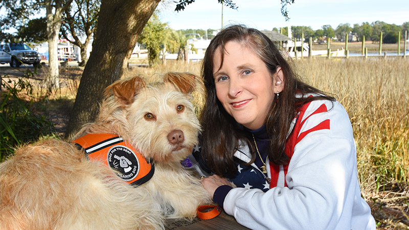 Outdoor image of a woman with service dog